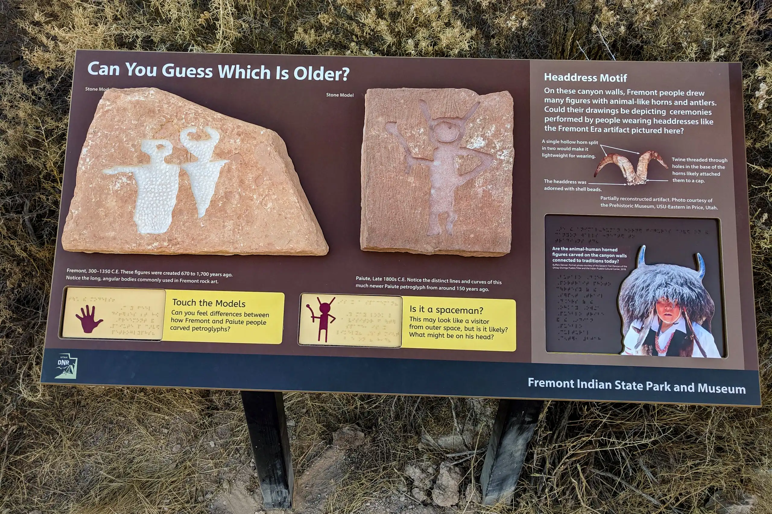 Informational sign with ancient rock art, a horned headdress photo, and educational text.