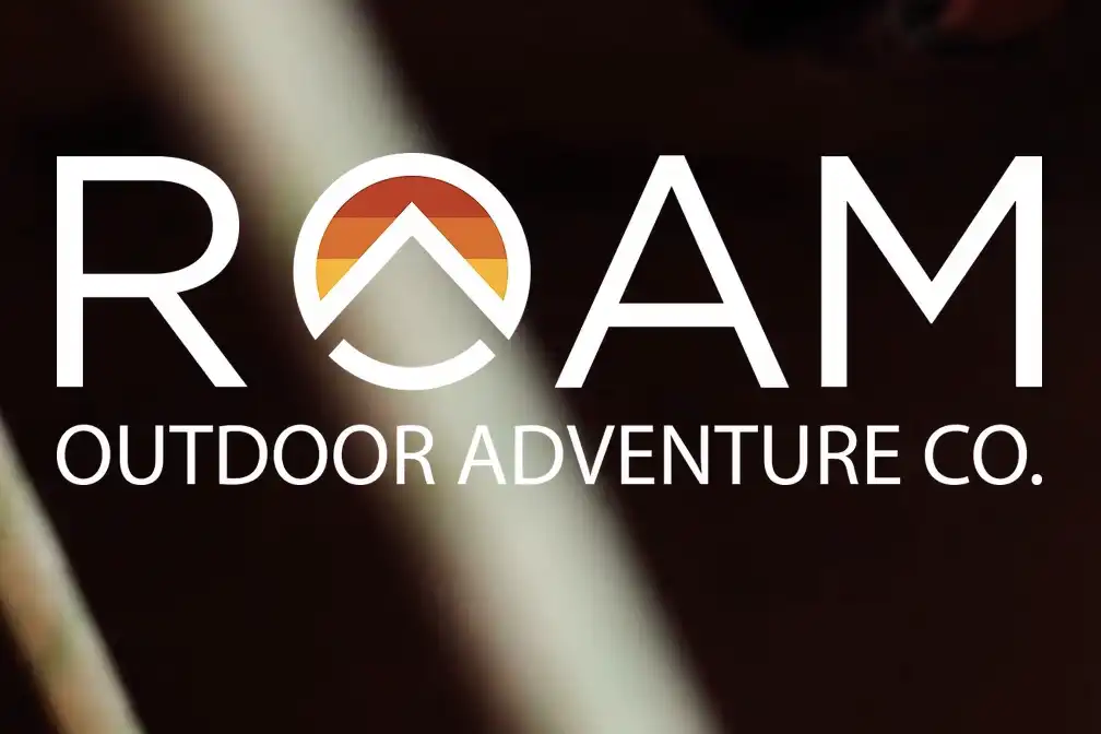 ROAM Outdoor Adventure Co. logo with a sunset graphic inside the letter O.