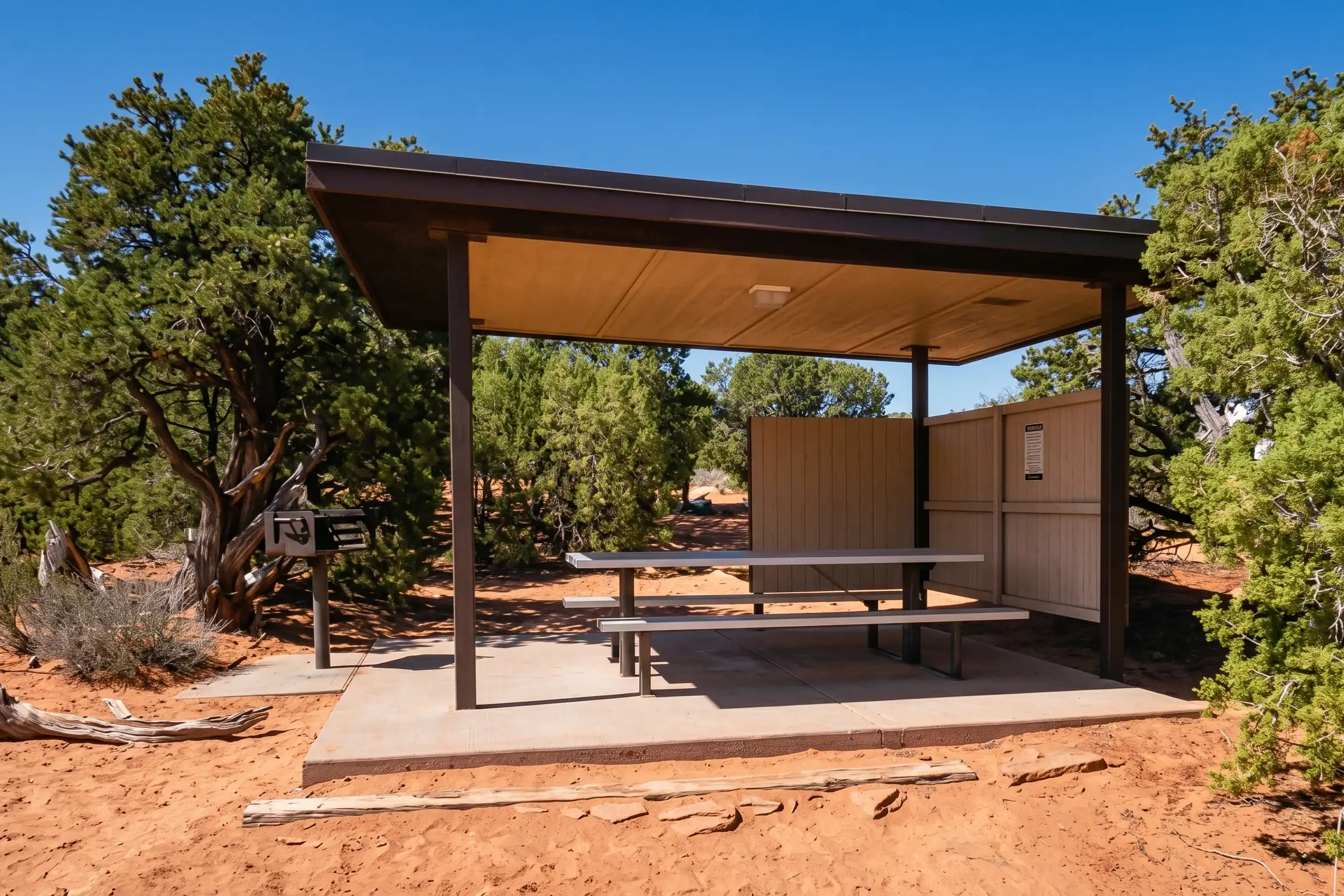 A shaded pavilion with a picnic table at Dead Horse Point State Park
