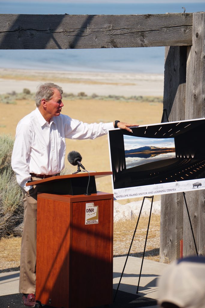 Charles Potter Jr speaks at a podium at the Antelope Island State Park groundbreaking ceremony